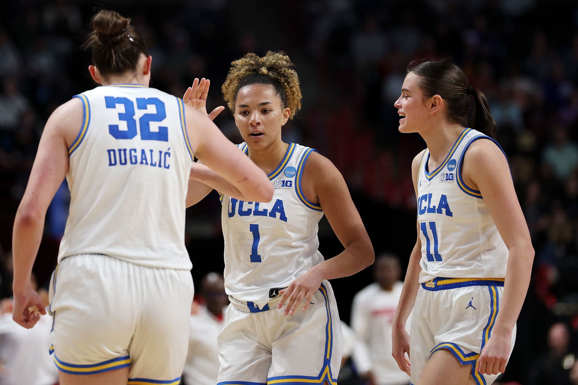 Angela Dugalić (#32), Kiki Rice (#1) and Gabriela Jaquez (#11) of the UCLA Bruins celebrate during their Sweet 16 game against the Ole Miss Rebels at Spokane Arena on March 28, 2025. Photo: Getty